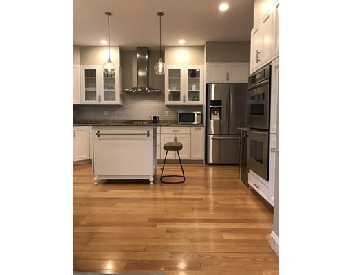 41 Trueman Street Needham, MA 02494 - Photo 5 of 24 a kitchen with stainless steel appliances granite countertop a refrigerator a stove and a sink