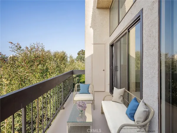 a balcony with wooden floor and furniture