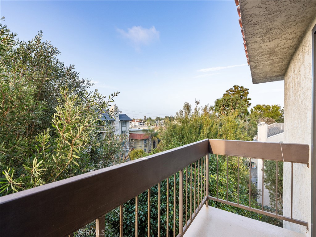 8180 Manitoba Street, Unit 302 Playa del Rey, CA 90293 - Photo 18 of 31 a view of a balcony with wooden fence and floor