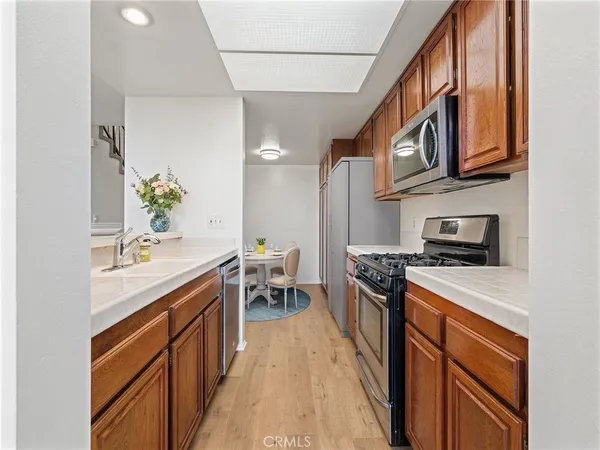 a kitchen with stainless steel appliances a stove a sink and a refrigerator