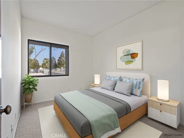 a bedroom with a bed and painting on the wall