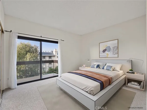 a bedroom with a bed lamp and window