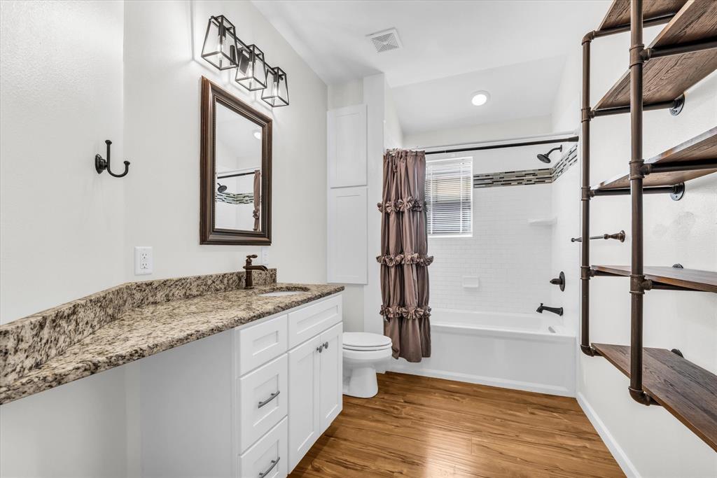 348 Barker Lane Waco, TX 76705 - Photo 8 of 39 a spacious bathroom with a granite countertop sink mirror vanity and a shower