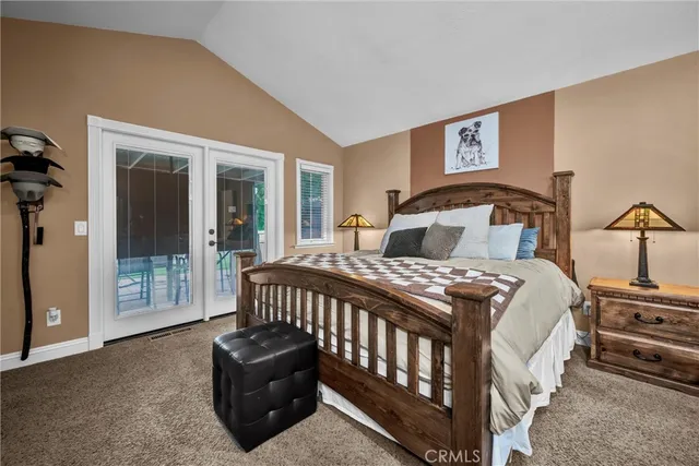 a bedroom with a bed and glass door