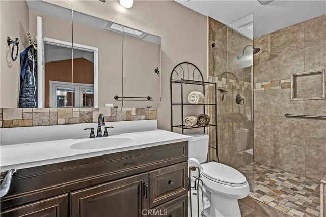 a bathroom with a sink toilet and shower