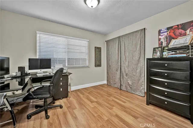 a view of a workspace with furniture and a window