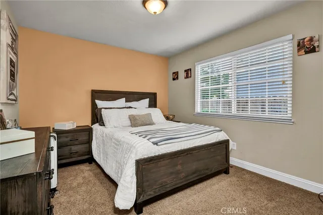 a bed sitting in a bedroom next to a window