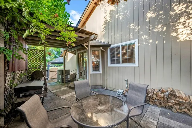 a view of a patio with couches table and chairs and potted plants
