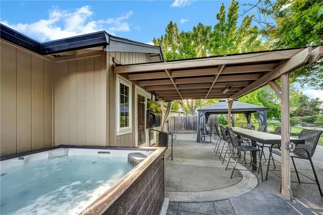 a patio with water view fountain with wooden floor and outdoor seating