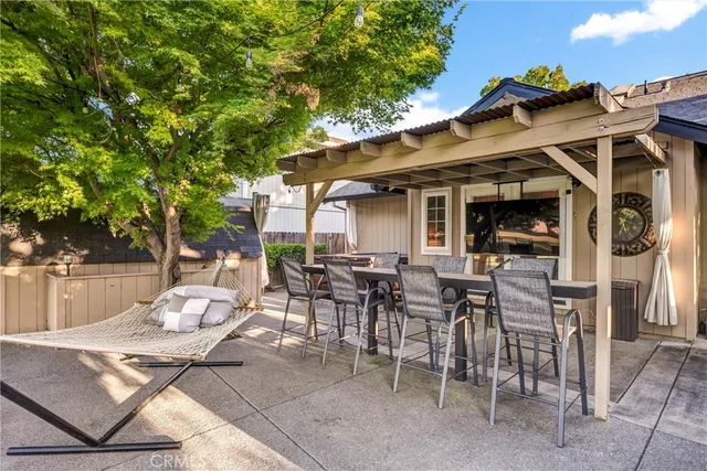 a view of a patio with table and chairs and potted plants