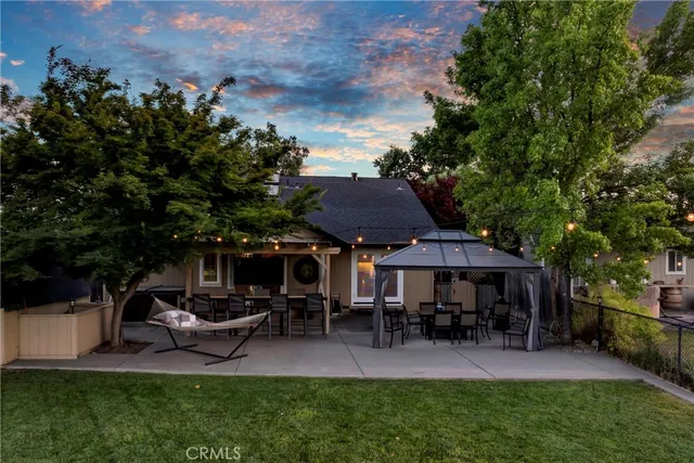 a view of a house with a yard and sitting area