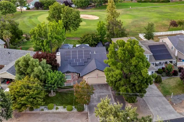 a aerial view of a house with a garden and lake view