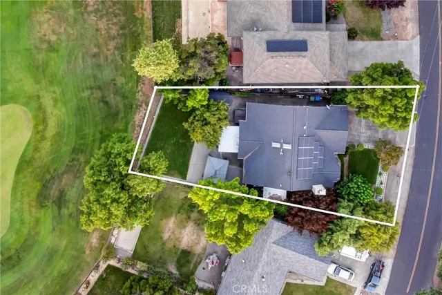 an aerial view of a house with a yard and a garden