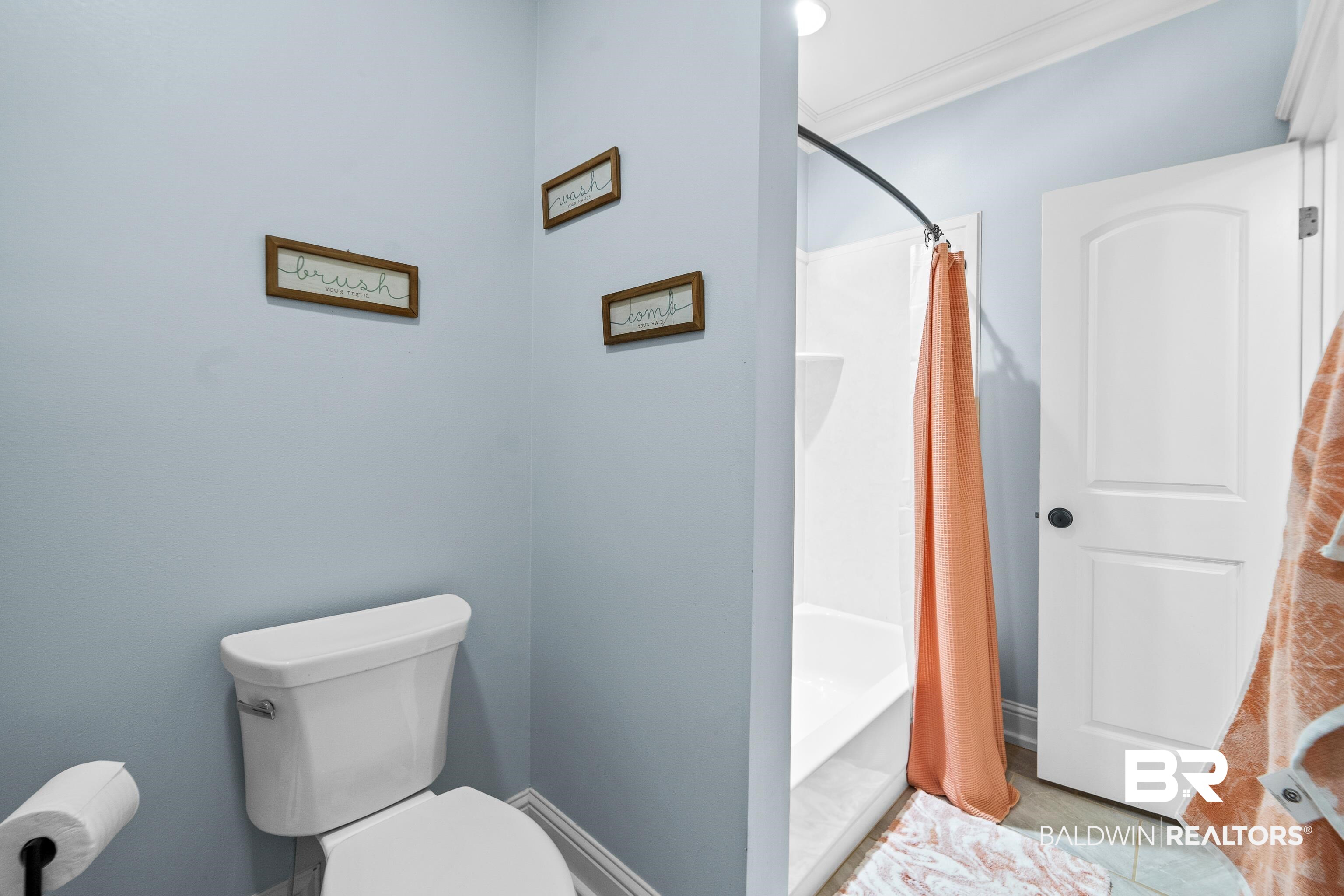 31829 Butler Drive Daphne, AL 36527 - Photo 33 of 48 Bathroom with shower / bathtub combination with curtain, crown molding, tile patterned floors, and toilet