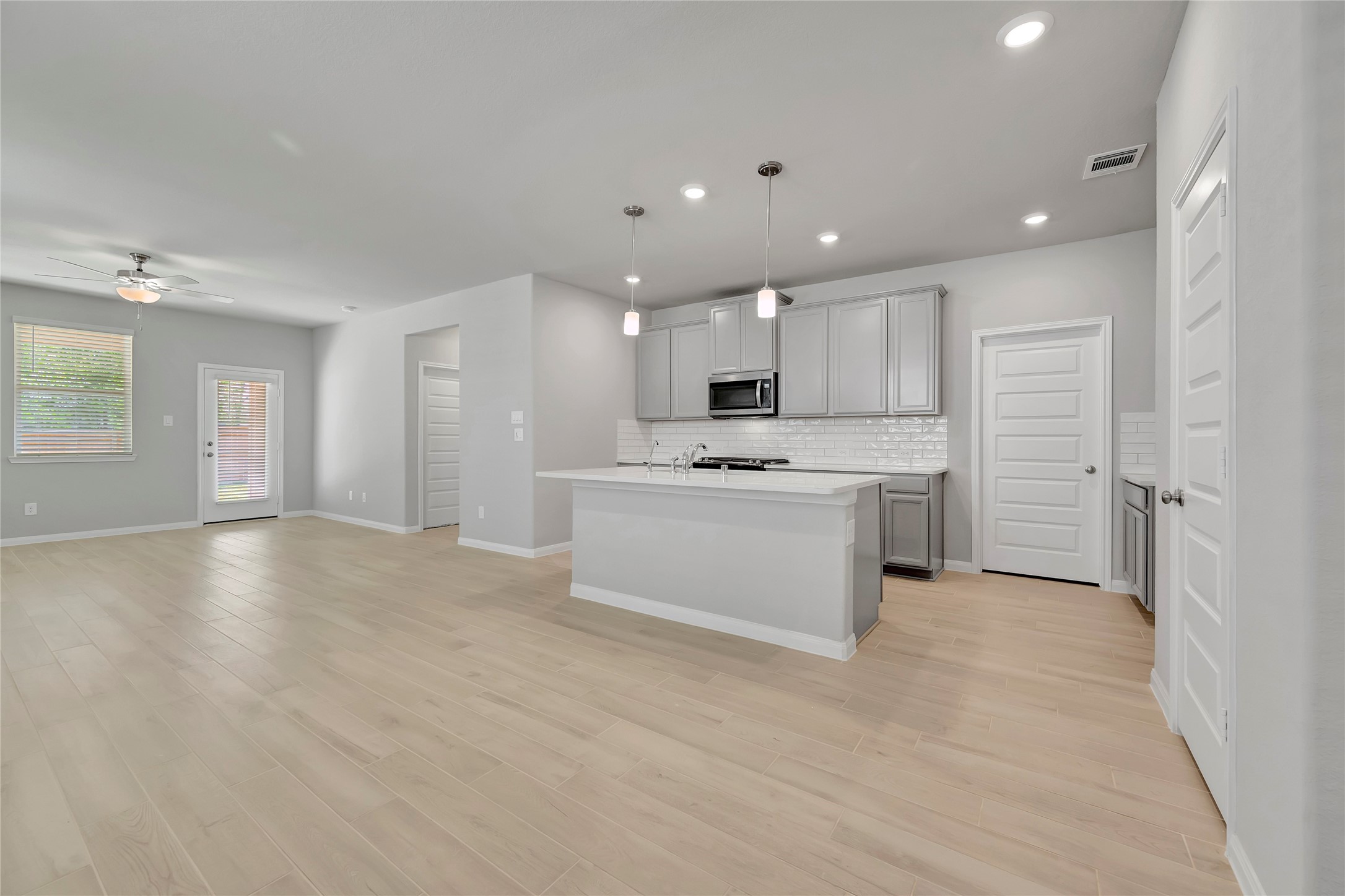 a view of kitchen electric appliances cabinets and a sink