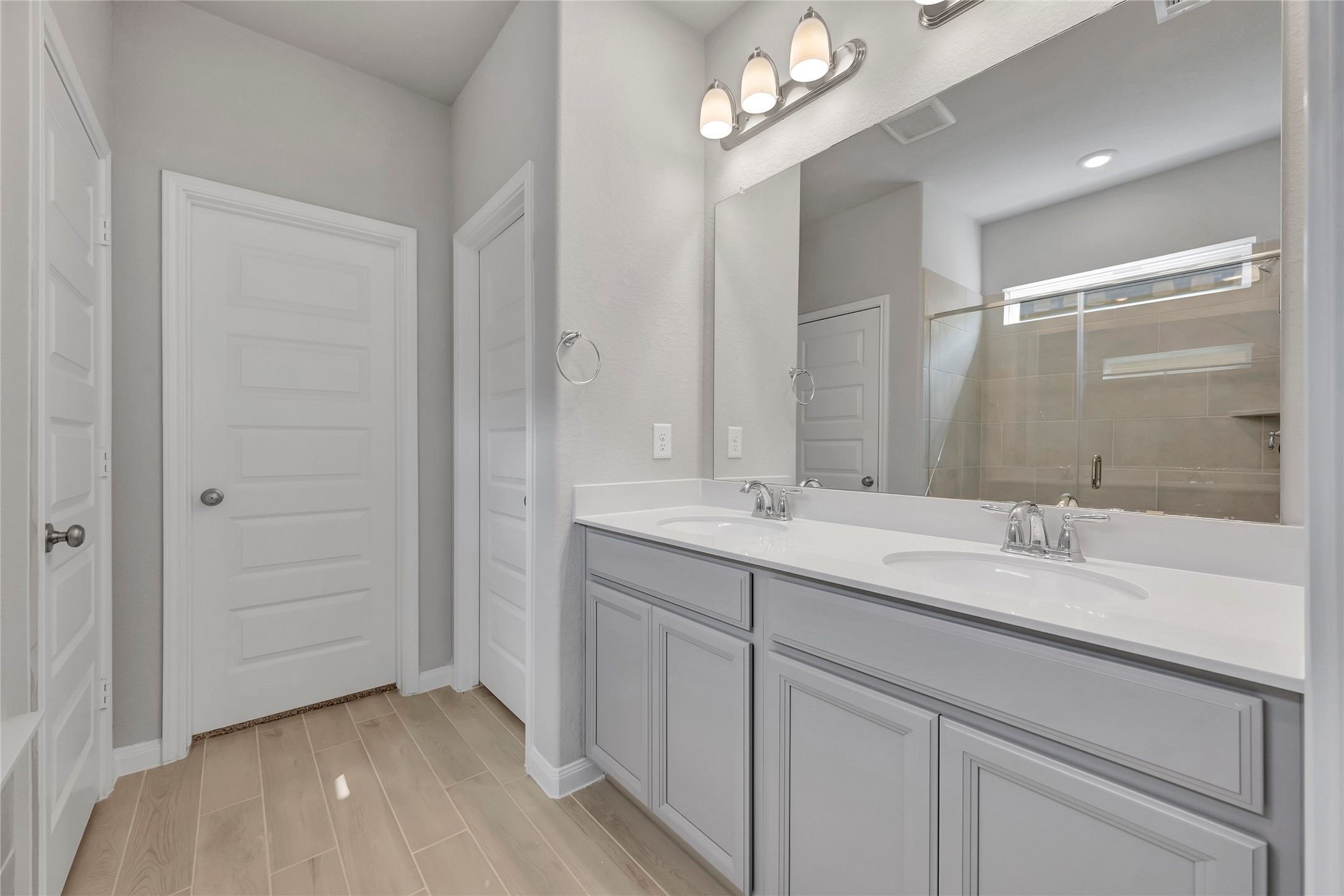 420 Sunrise Ranch Drive Montgomery, TX 77316 - Photo 13 of 26 a bathroom with a double vanity sink a large mirror and shower