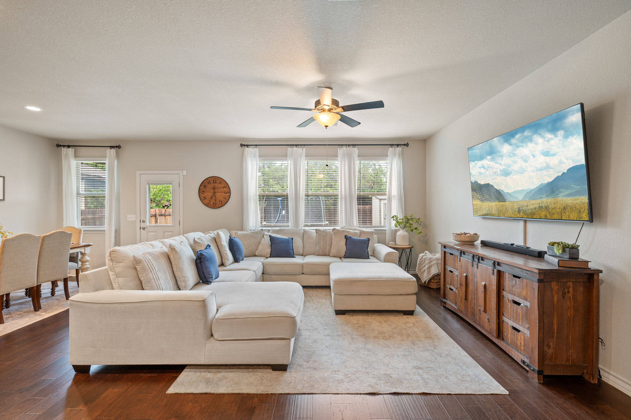 409 Limestone Road Liberty Hill, TX 78642 - Photo 13 of 35 a living room with furniture a flat screen tv and a large window