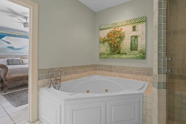 a bathroom with a tub and a painting on the wall