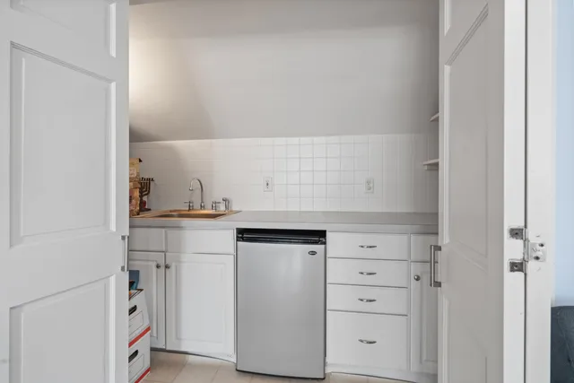 a kitchen with stove and cabinets