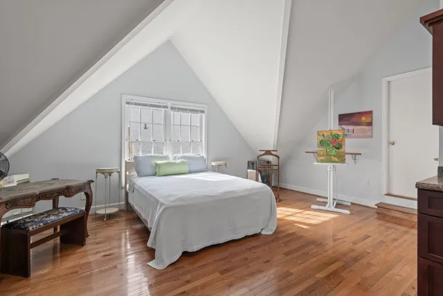 a bed room with a bed and a chandelier