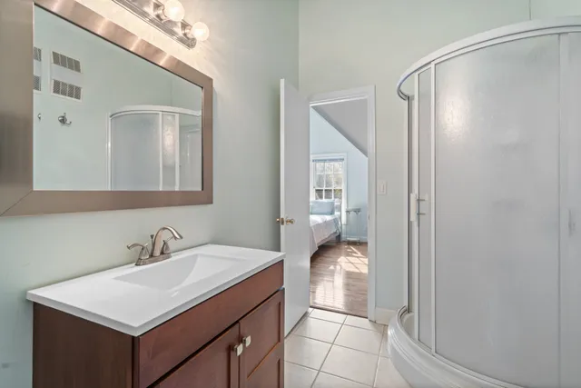 a view of a white house with large windows and a table