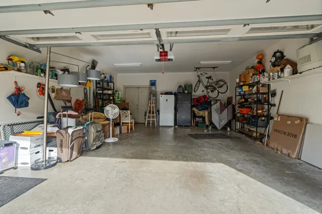 a view of a patio with chairs and potted plants