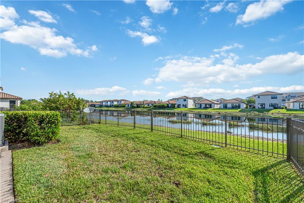 8732 Madrid Circle Naples, FL 34104 - Photo 14 of 15 View of yard with a water view