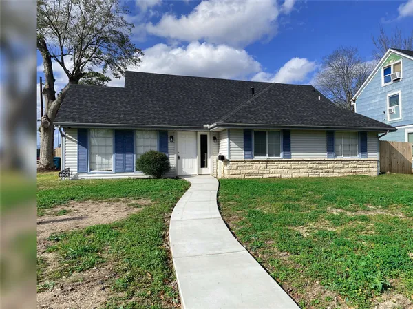 a front view of a house with a garden and yard