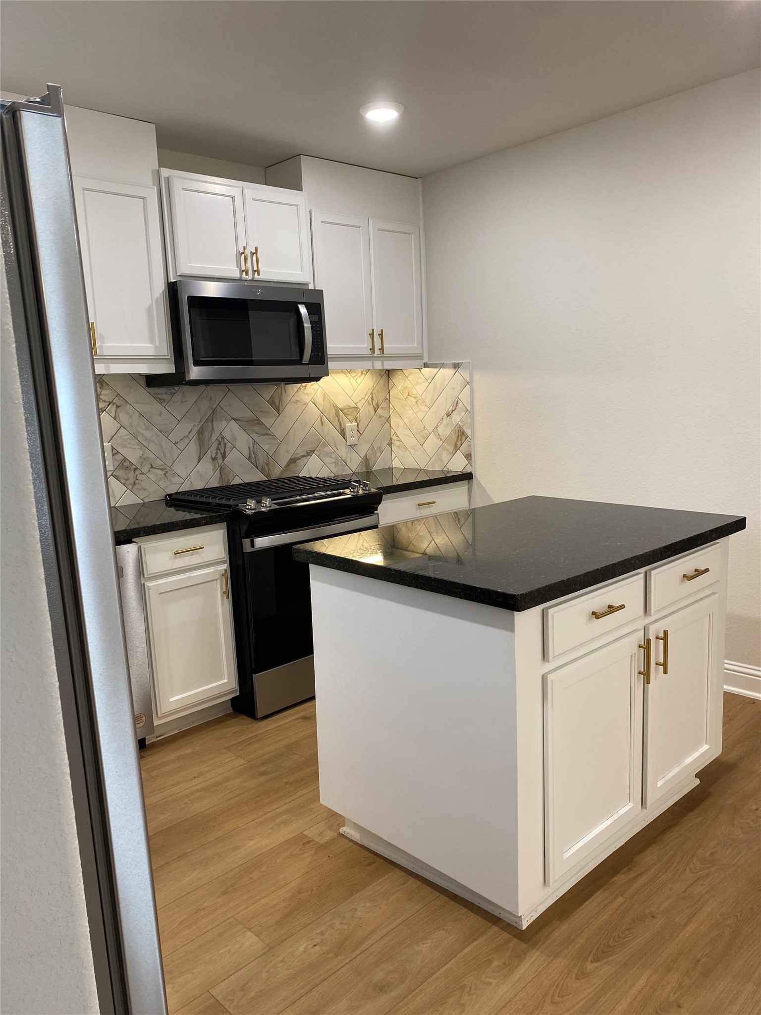 4901 Winnetka Street Houston, TX 77021 - Photo 12 of 45 a kitchen with granite countertop white cabinets and a stainless steel appliances