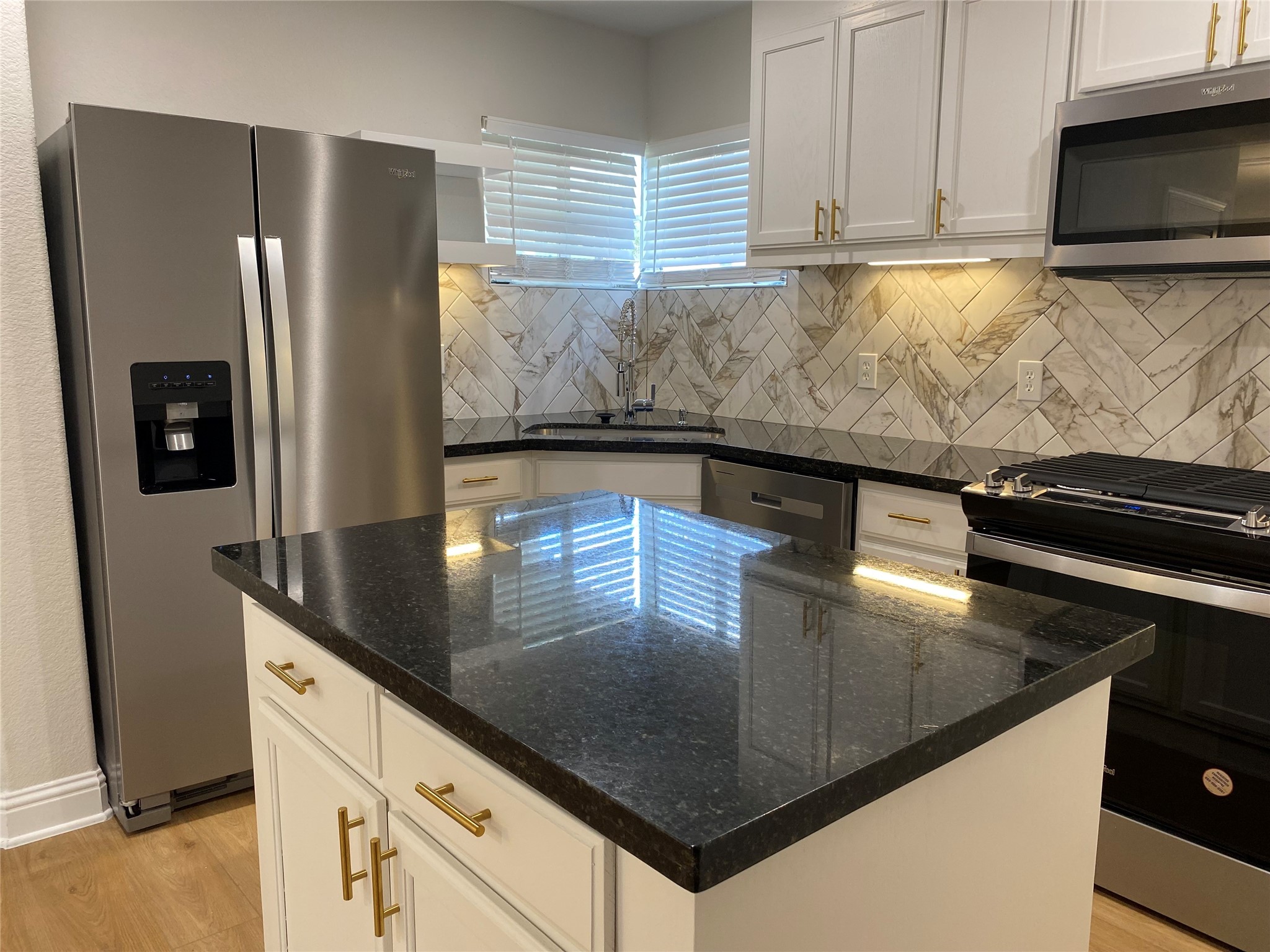 4901 Winnetka Street Houston, TX 77021 - Photo 13 of 45 a kitchen with stainless steel appliances granite countertop a sink a stove and a refrigerator