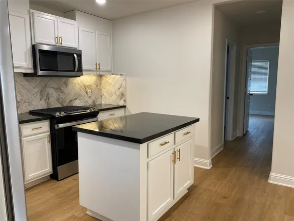 a kitchen with a stove and a microwave
