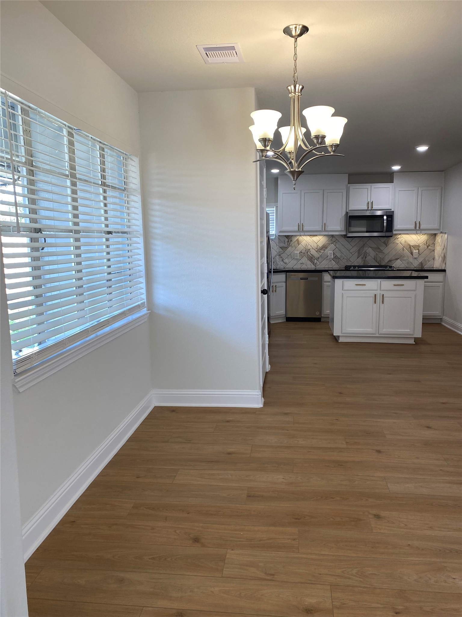4901 Winnetka Street Houston, TX 77021 - Photo 16 of 45 a kitchen with kitchen island a sink stainless steel appliances and cabinets