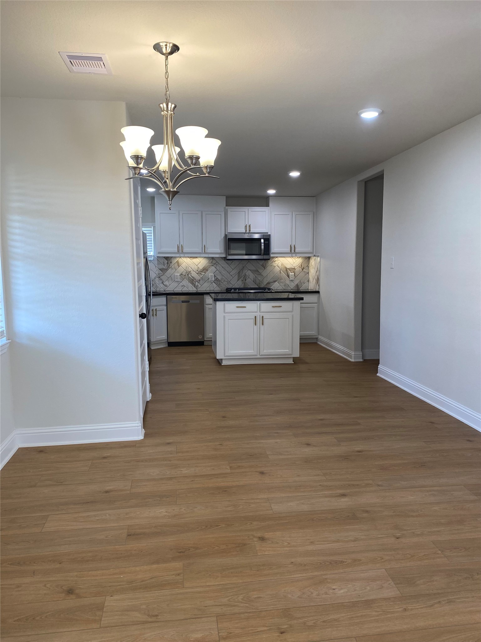 4901 Winnetka Street Houston, TX 77021 - Photo 18 of 45 a kitchen with a sink stainless steel appliances and chandelier