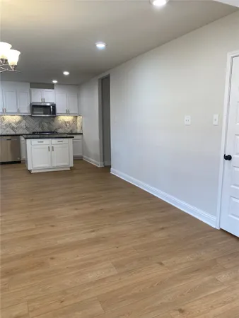 a large kitchen with stainless steel appliances granite countertop a stove a sink and a refrigerator