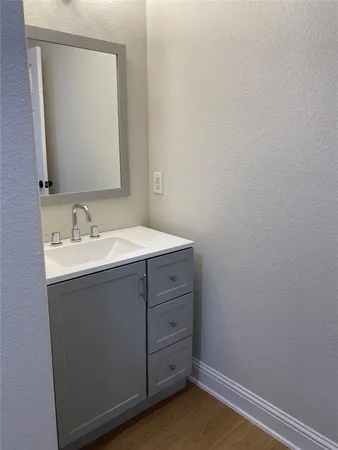 a bathroom with a sink vanity and a mirror