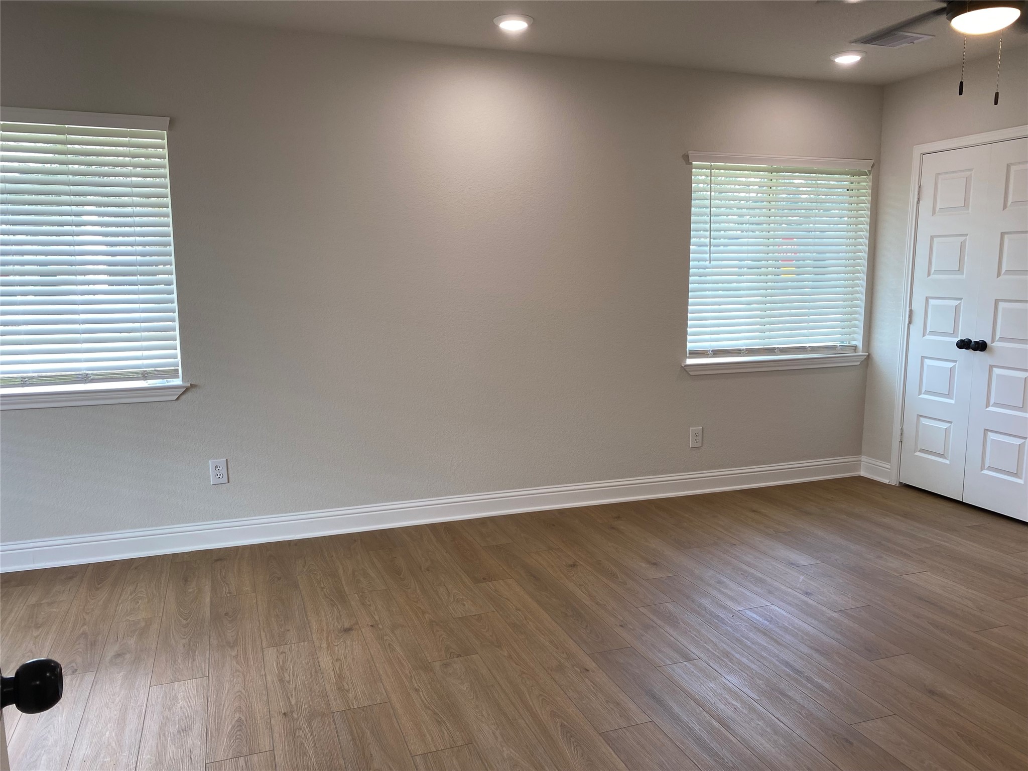 4901 Winnetka Street Houston, TX 77021 - Photo 25 of 45 an empty room with wooden floor and windows