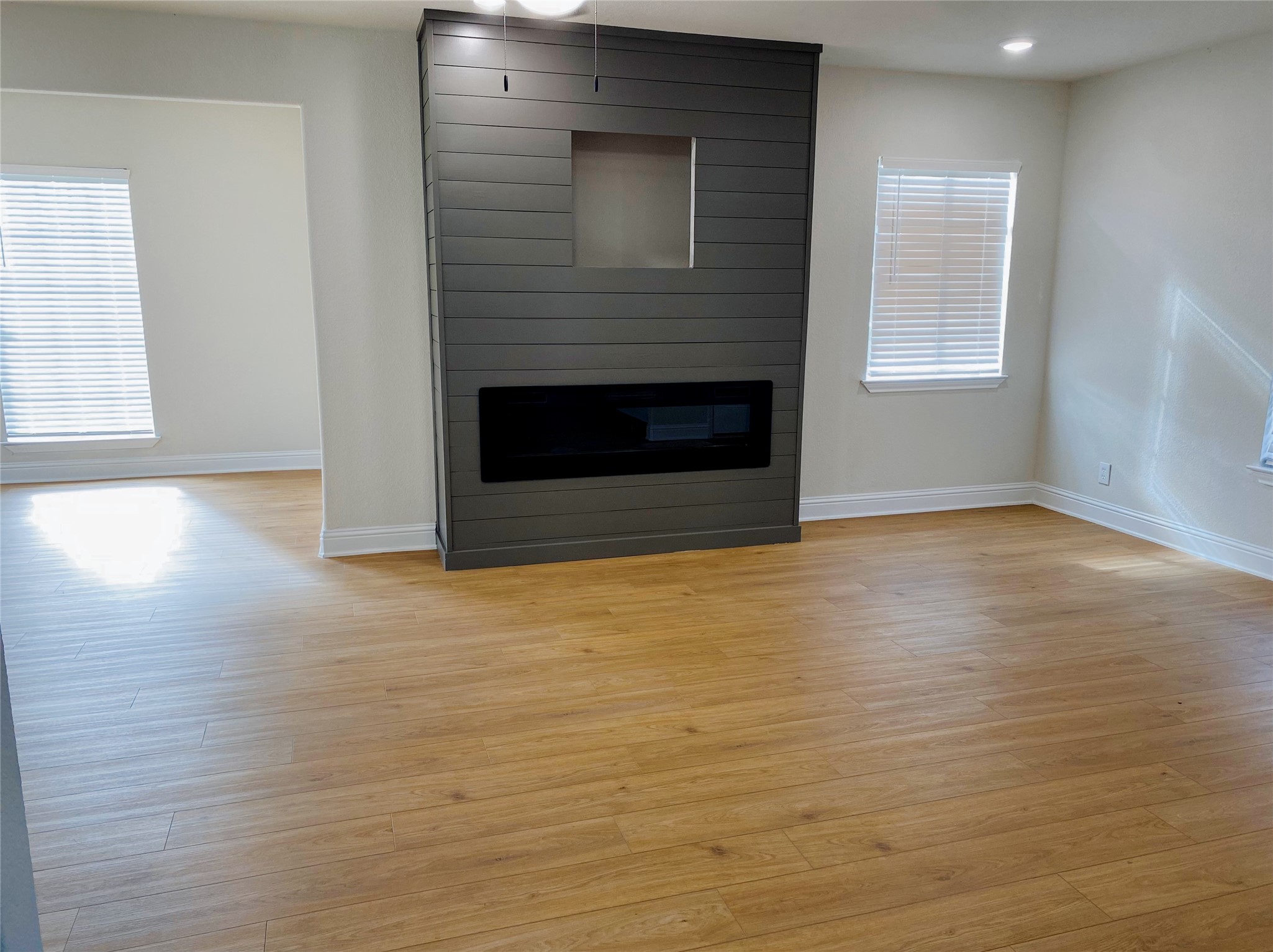 4901 Winnetka Street Houston, TX 77021 - Photo 45 of 45 an empty room with wooden floor and fireplace