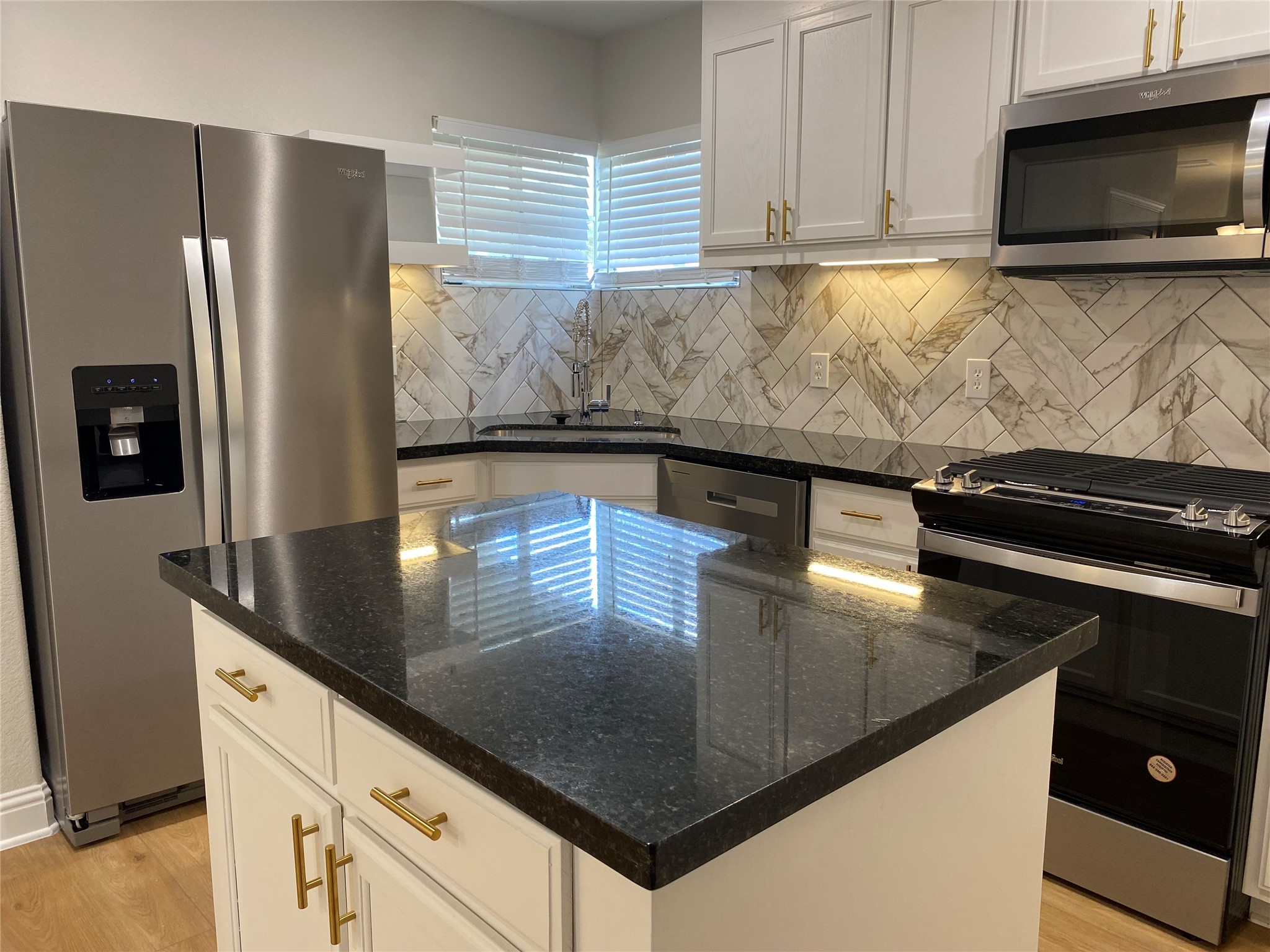 4901 Winnetka Street Houston, TX 77021 - Photo 6 of 45 a kitchen with stainless steel appliances granite countertop a sink a stove and a microwave