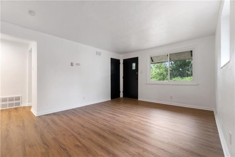 546 Old Frankstown Road Monroeville, PA 15146 - Photo 12 of 47 an empty room with wooden floor and windows