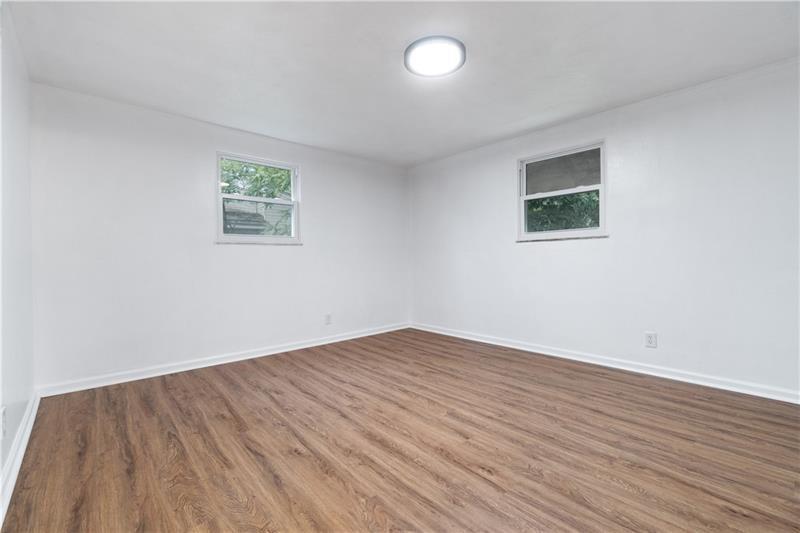 546 Old Frankstown Road Monroeville, PA 15146 - Photo 14 of 47 an empty room with wooden floor and windows