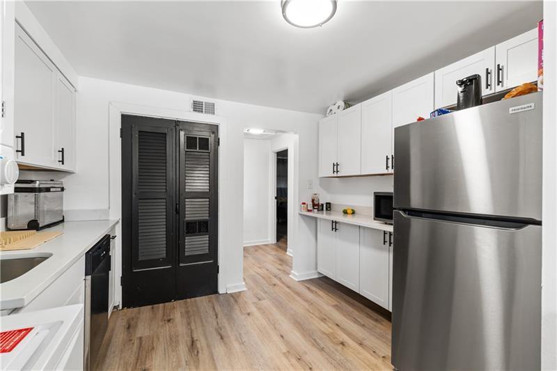 546 Old Frankstown Road Monroeville, PA 15146 - Photo 22 of 47 a kitchen with stainless steel appliances a refrigerator a sink and wooden cabinets