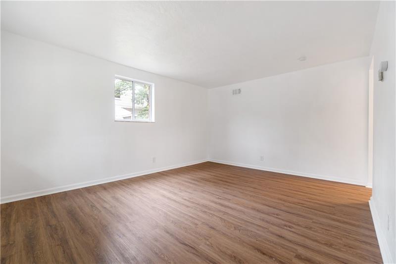 546 Old Frankstown Road Monroeville, PA 15146 - Photo 10 of 47 an empty room with wooden floor and windows