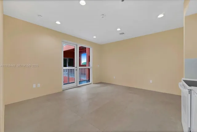 a view of an empty room with a fireplace