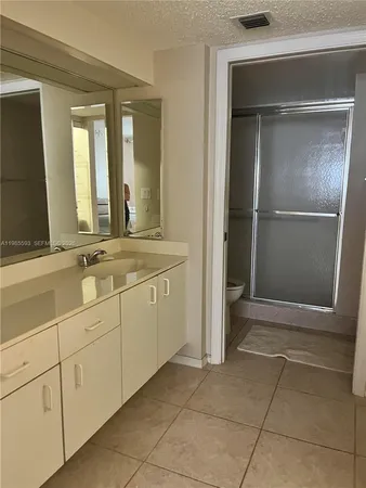 a spacious bathroom with a mirror sink and