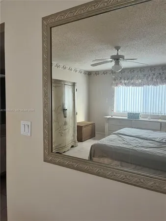 a bedroom with a bed and a mirror