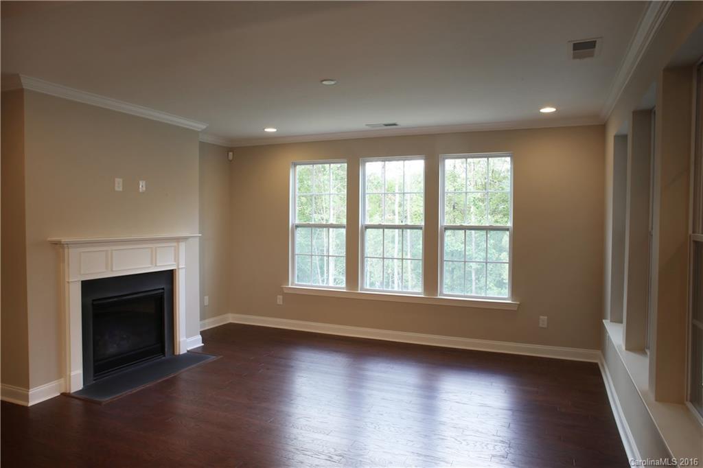 1033 Emory Lane, Unit 70 Fort Mill, SC 29708 - Photo 6 of 21 an empty room with wooden floor and fireplace