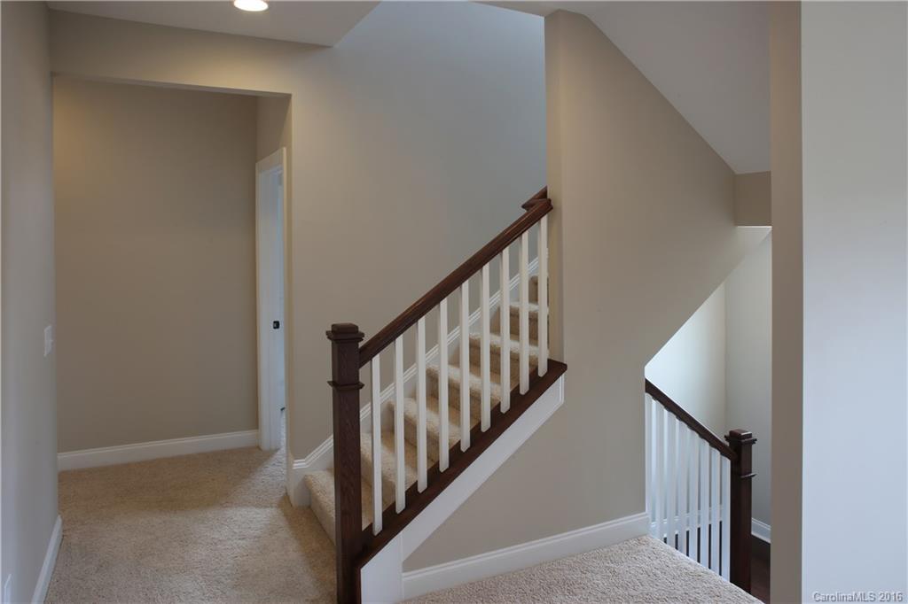 1033 Emory Lane, Unit 70 Fort Mill, SC 29708 - Photo 9 of 21 a view of staircase with lots of frames on wall