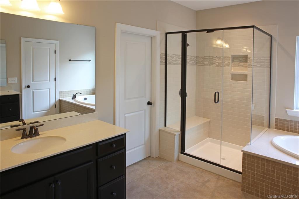 1033 Emory Lane, Unit 70 Fort Mill, SC 29708 - Photo 10 of 21 a bathroom with a shower sink and mirror