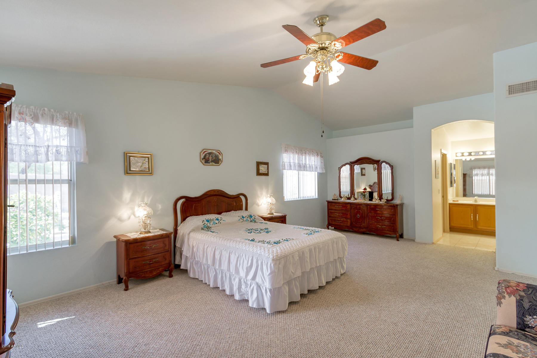 3941 West Charter Oak Road Phoenix, AZ 85029 - Photo 14 of 25 a bedroom with a bed a chandelier and a window
