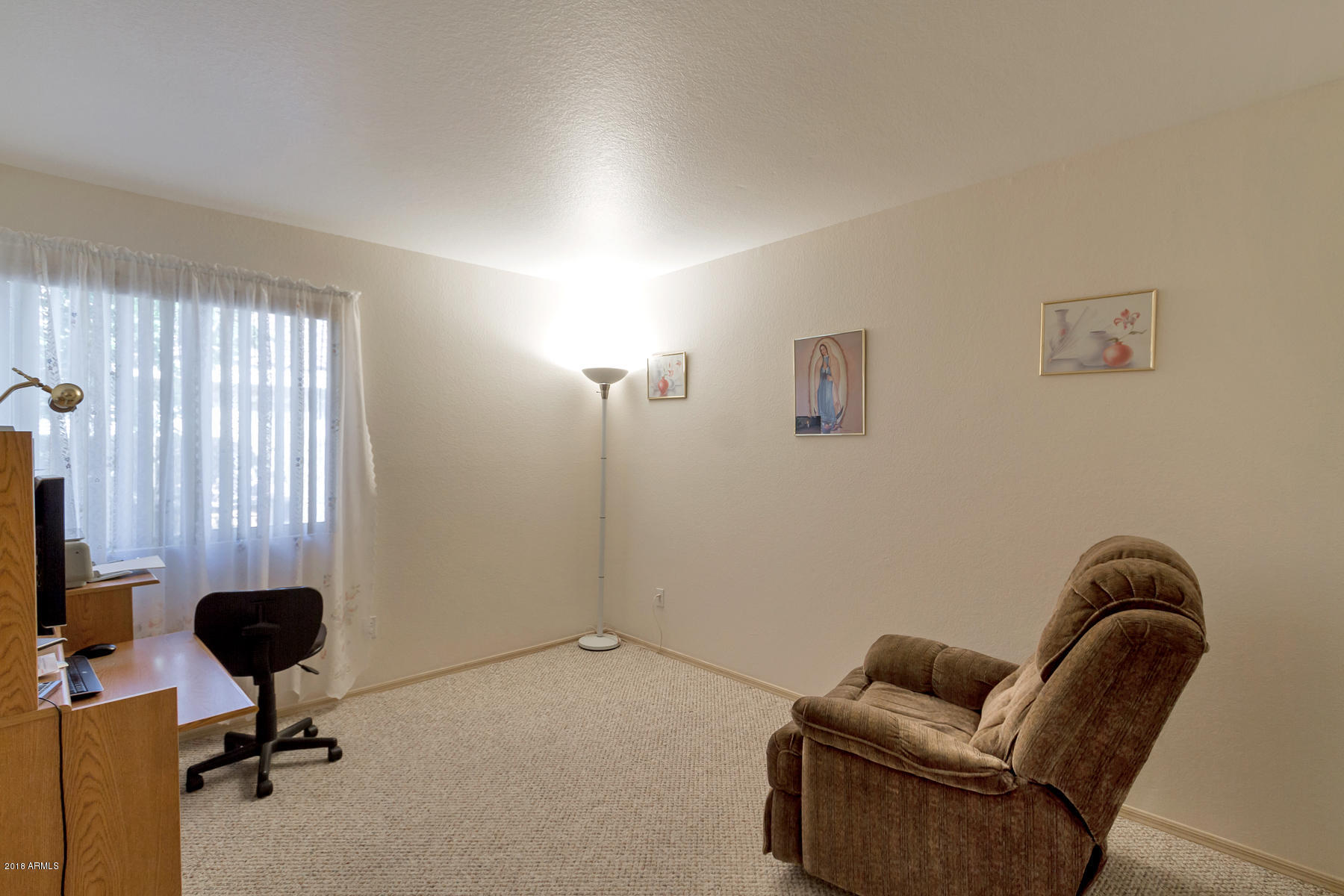 3941 West Charter Oak Road Phoenix, AZ 85029 - Photo 16 of 25 a living room with furniture and a window